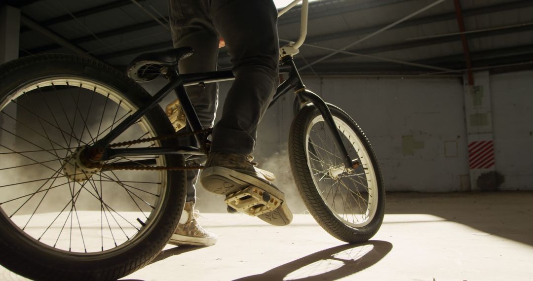 BMX Biker Practicing Tricks in Abandoned Warehouse - Free Images, Stock Photos and Pictures on Pikwizard.com