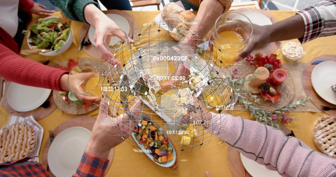 Friends Toasting with Orange Juice at Holiday Table with Holographic Globe