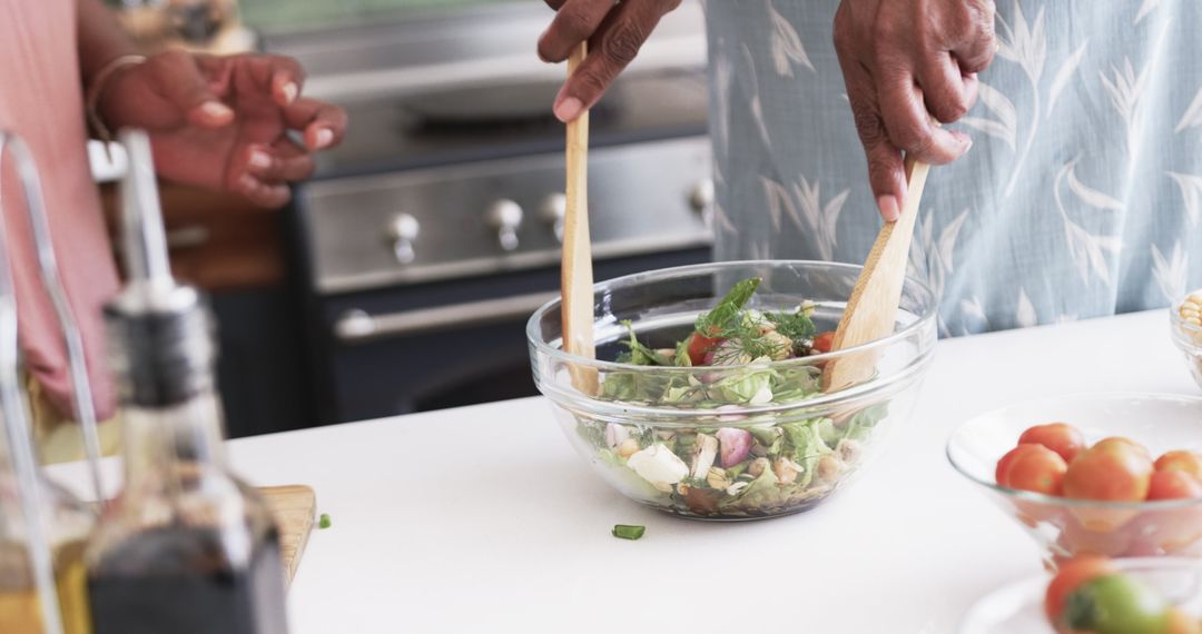 Close-Up of Friends Preparing Fresh Salad in Kitchen