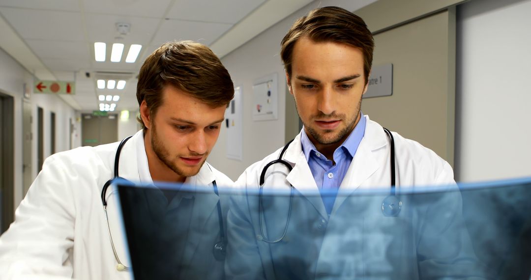 Two Young Doctors Discussing X-Ray in Modern Hospital - Free Images, Stock Photos and Pictures on Pikwizard.com