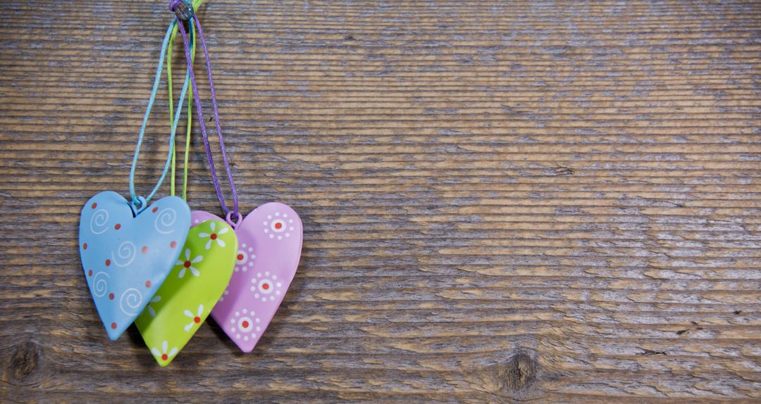 Colorful Wooden Hearts Hanging on Rustic Wood Surface - Free Images, Stock Photos and Pictures on Pikwizard.com