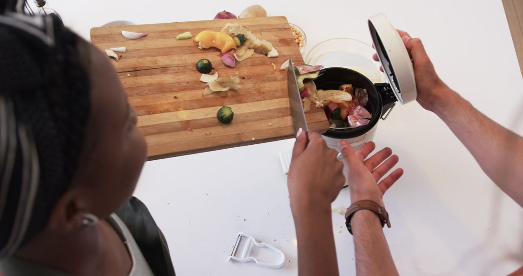 Diverse Household Engaging in Sustainable Kitchen Composting