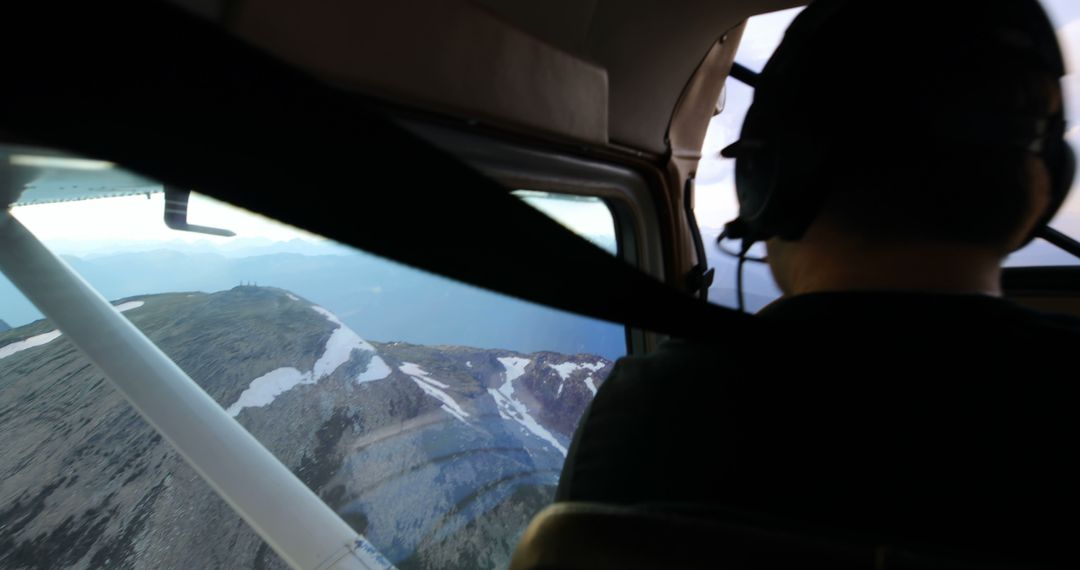 Pilot Flying Small Aircraft Over Snow-Capped Mountains - Free Images, Stock Photos and Pictures on Pikwizard.com