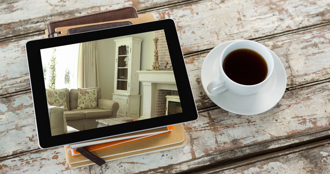 Tablet Displaying Cozy Living Room Beside Coffee Cup on Rustic Table
