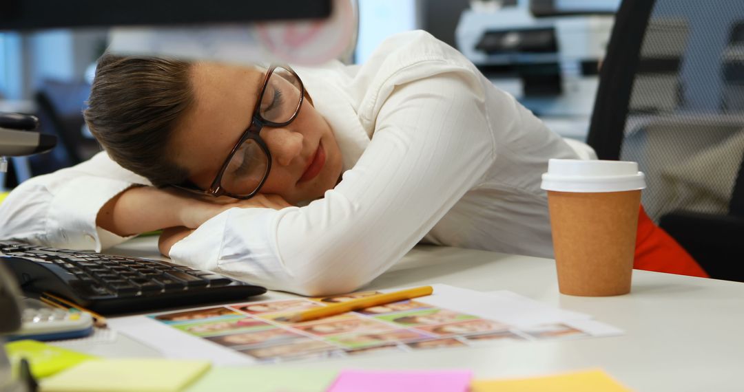 Businesswoman Napping at Office Desk Reflecting Workplace Exhaustion