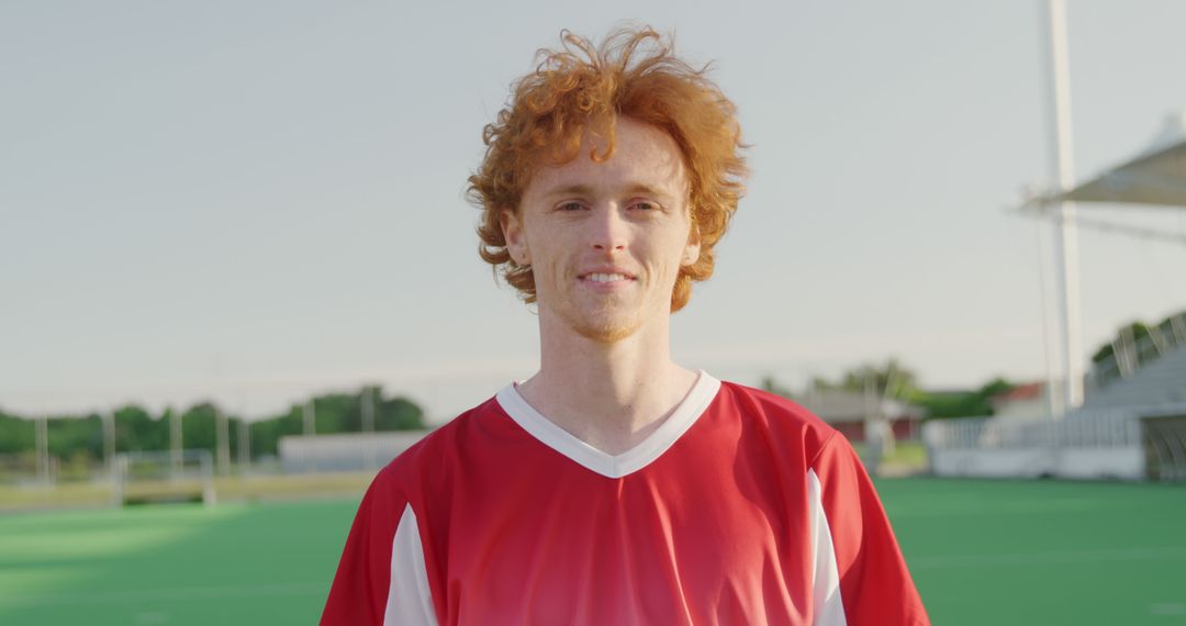 Redhead Male Hockey Player in Team Jersey on Field