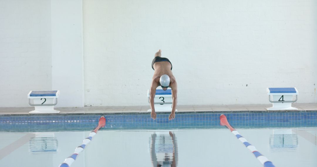 Swimmer Diving Into Pool During Competitive Swim Race