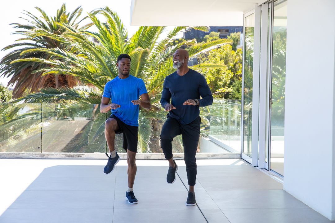 Father and Son Exercising on Balcony with Scenic View