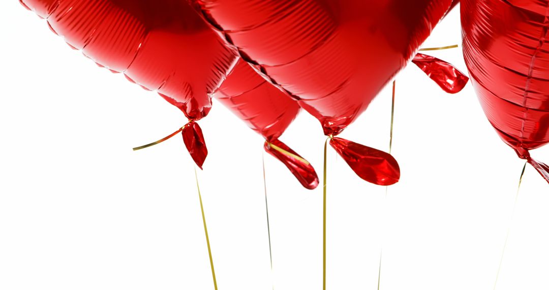 Red heart-shaped helium balloons on white background - Free Images, Stock Photos and Pictures on Pikwizard.com
