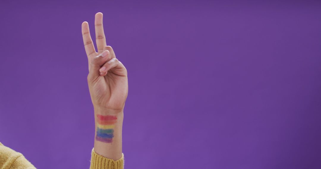Hand Showing Peace Sign with LGBTQ+ Tattoo Against Purple Background - Free Images, Stock Photos and Pictures on Pikwizard.com
