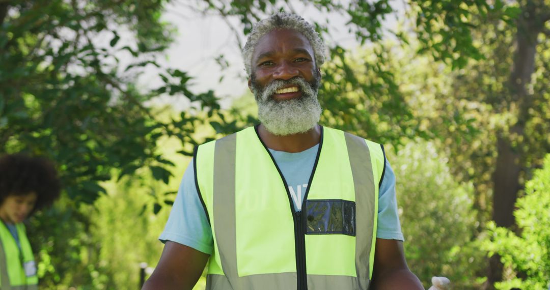 Smiling Senior Man Volunteering Outdoors in High Visibility Vest - Free Images, Stock Photos and Pictures on Pikwizard.com