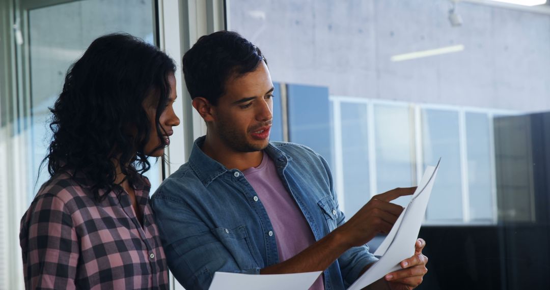 Collaborative Team Reviewing Documents in Office Setting
