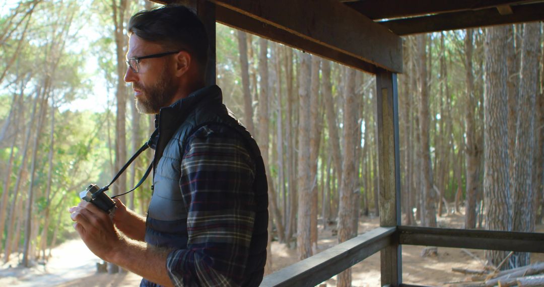 Man Observing Pine Forest from Viewing Deck in Wilderness