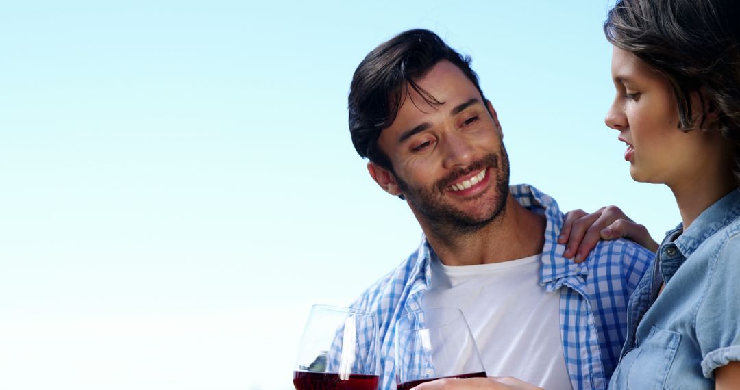 Cheerful Couple Enjoying Wine Outdoors in Relaxed Interlude