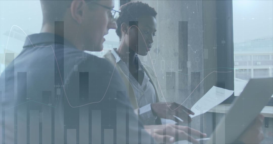 Business Colleagues Analyzing Data Graphics in Office Setting