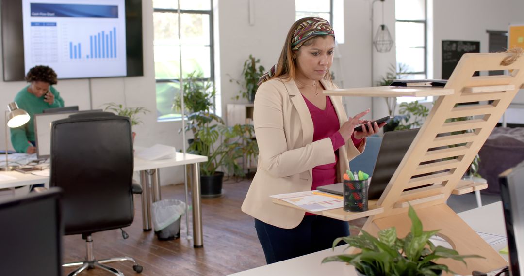 Casual Businesswoman Multitasking in Modern Office Environment