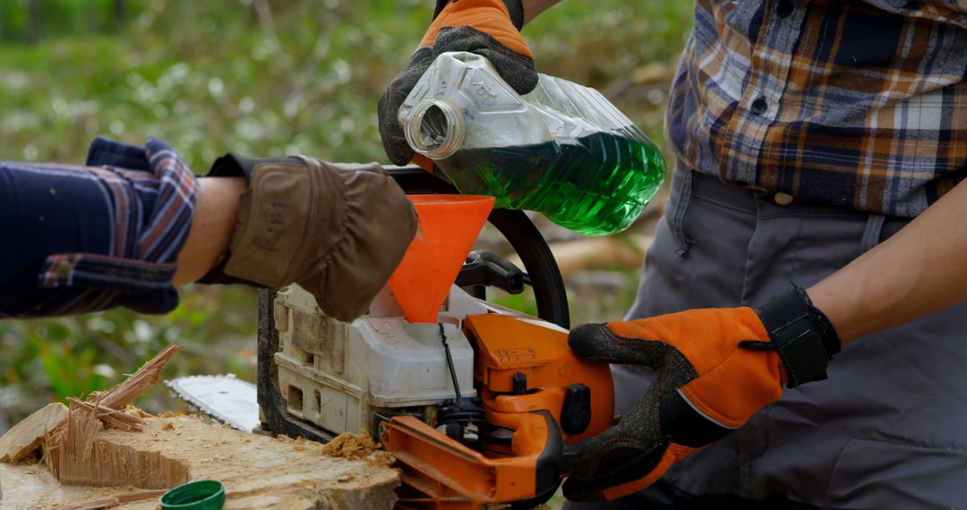 Refueling Chainsaw for Outdoor Woodcutting Activity - Free Images, Stock Photos and Pictures on Pikwizard.com