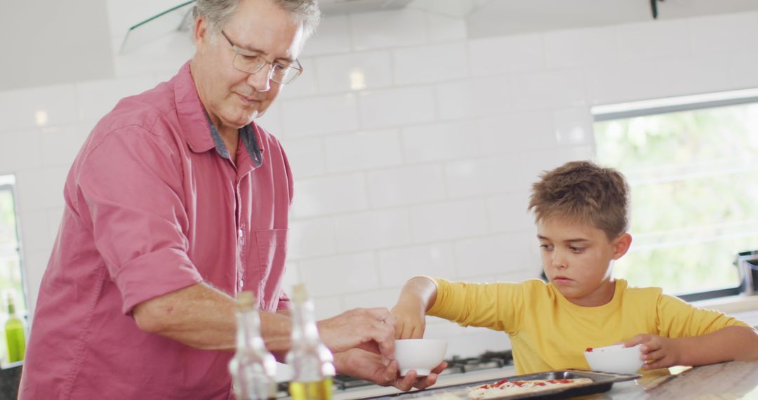 Grandfather and Grandson Making Pizza Together in Kitchen - Free Images, Stock Photos and Pictures on Pikwizard.com