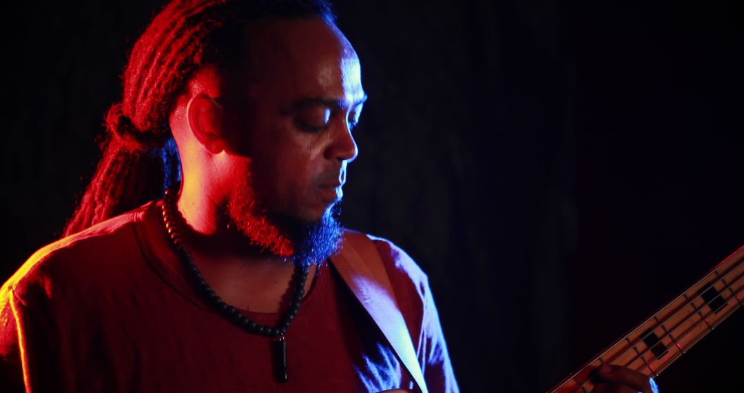 Electric Guitarist Performing on Stage in Low Light