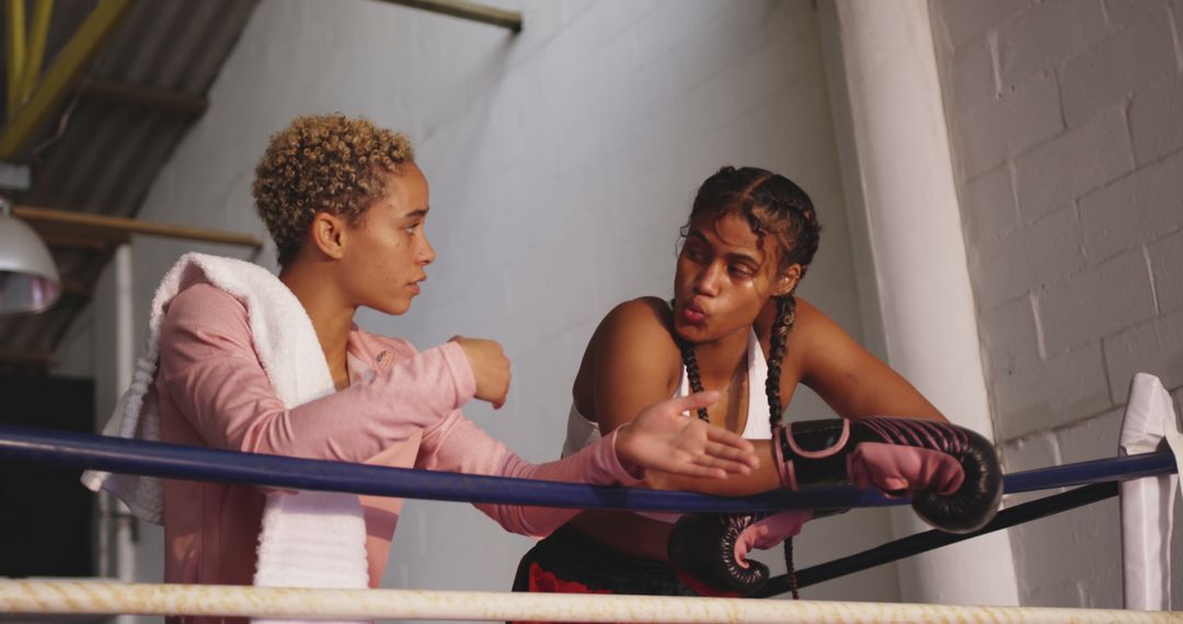 Two Female Boxers Discussing Strategy in a Gym - Free Images, Stock Photos and Pictures on Pikwizard.com