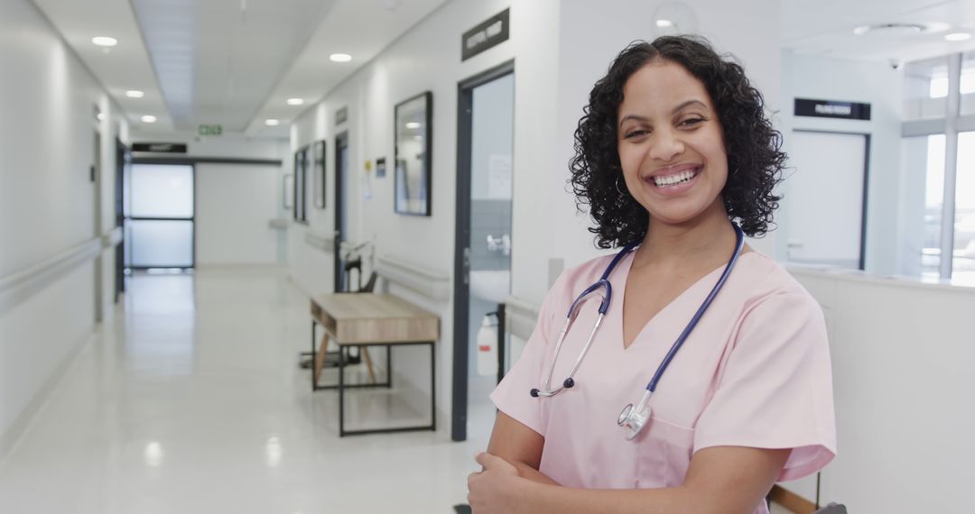 Smiling Nurse Standing in Hospital Corridor with Stethoscope - Free Images, Stock Photos and Pictures on Pikwizard.com