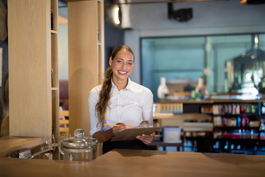 Friendly Receptionist Smiling at Modern Desk with Clipboard