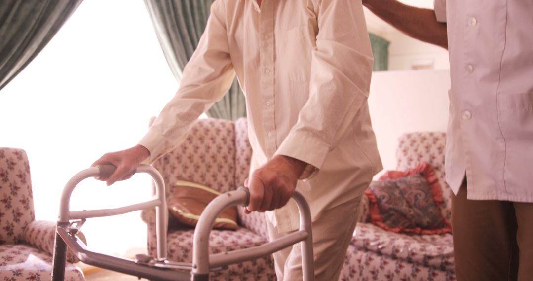 Elderly person using walker with caregiver at home - Free Images, Stock Photos and Pictures on Pikwizard.com