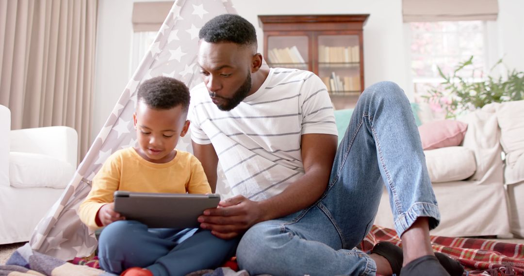 African American Father and Son Using Digital Tablet Together - Free Images, Stock Photos and Pictures on Pikwizard.com