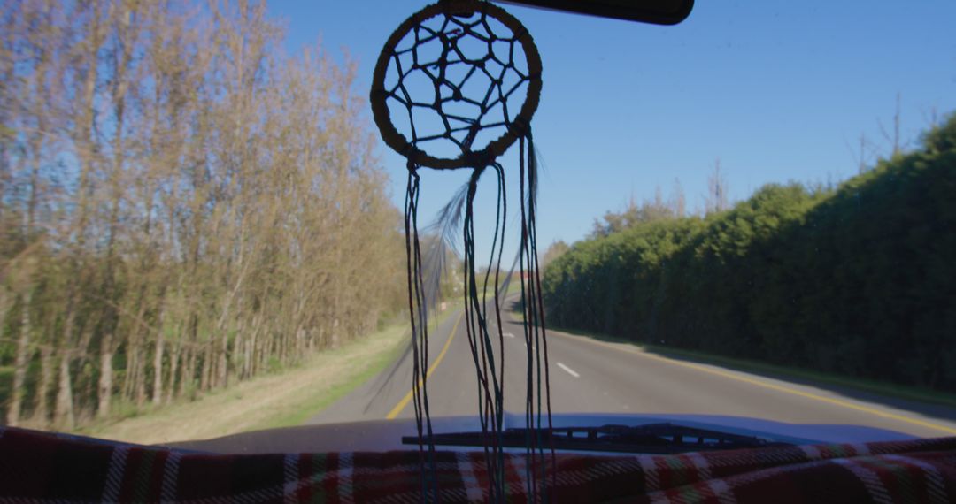 Dreamcatcher Hanging Inside Car During Road Trip on Sunny Day - Free Images, Stock Photos and Pictures on Pikwizard.com