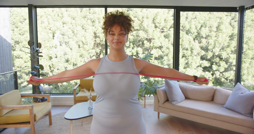 Fit African American Woman Exercising with Resistance Band at Home