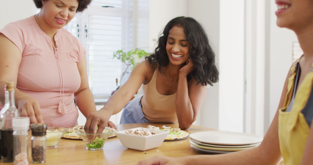 Diverse Women Enjoying Lighthearted Cooking at Home - Free Images, Stock Photos and Pictures on Pikwizard.com