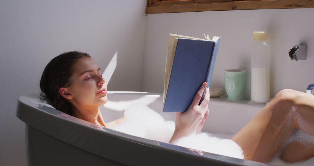 Woman Relaxing in Bathtub with Book and Bubble Bath - Free Images, Stock Photos and Pictures on Pikwizard.com