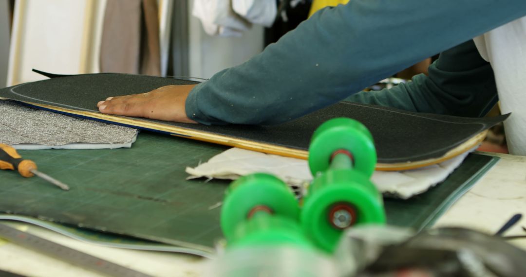 Person Assembling Skateboard by Hand in Workshop - Free Images, Stock Photos and Pictures on Pikwizard.com