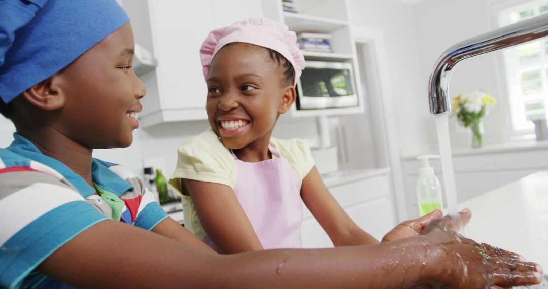 Children Smiling and Washing Hands in Kitchen - Free Images, Stock Photos and Pictures on Pikwizard.com