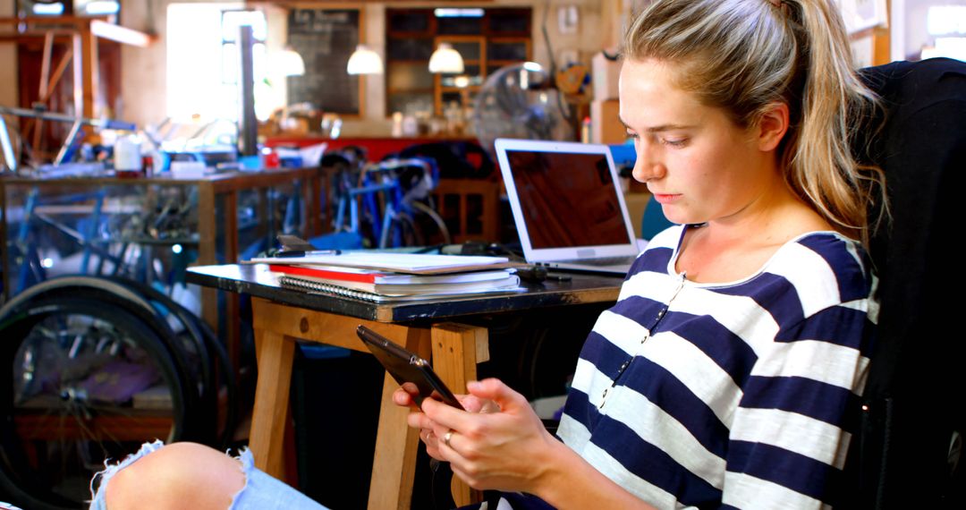 Young Woman Using Tablet in Bicycle Repair Workshop - Free Images, Stock Photos and Pictures on Pikwizard.com