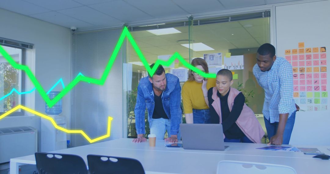 Diverse Team Analyzing Business Data with Laptops and Graphs in Modern Office