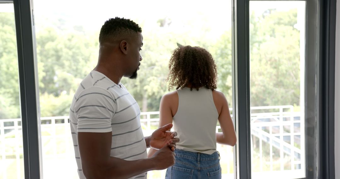 Serious Couple Discussion by Window in Modern Home