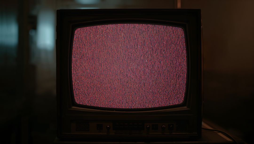 Vintage CRT TV Displaying Static in Dimly Lit Basement