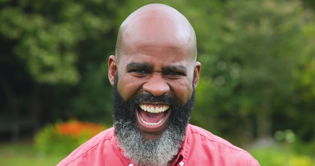 Smiling Man Enjoying Outdoor Garden in Red Shirt