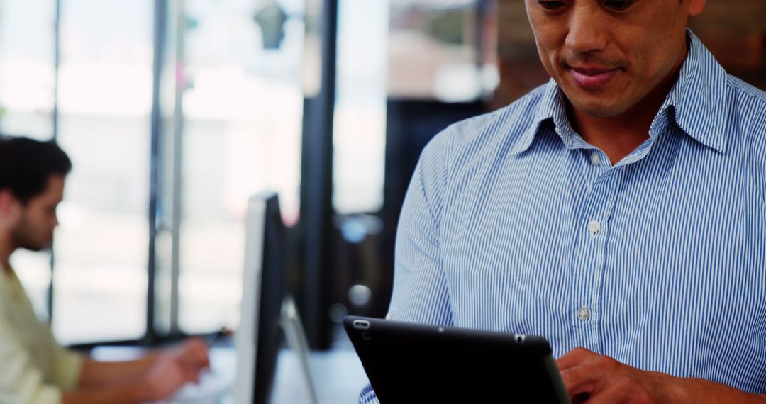 Focused Business Professional Using Digital Tablet Indoors