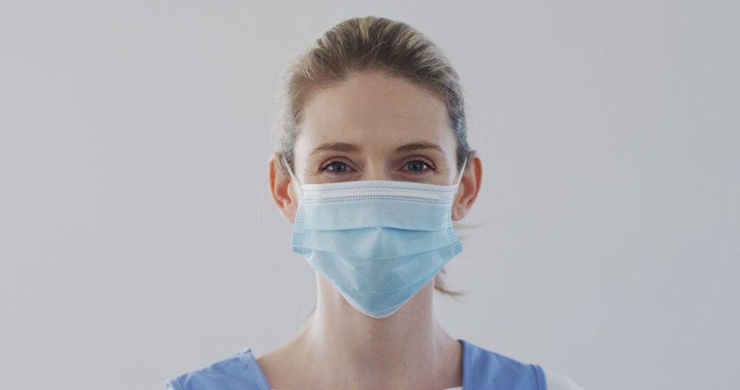 Female Healthcare Worker Wearing a Blue Medical Mask - Free Images, Stock Photos and Pictures on Pikwizard.com