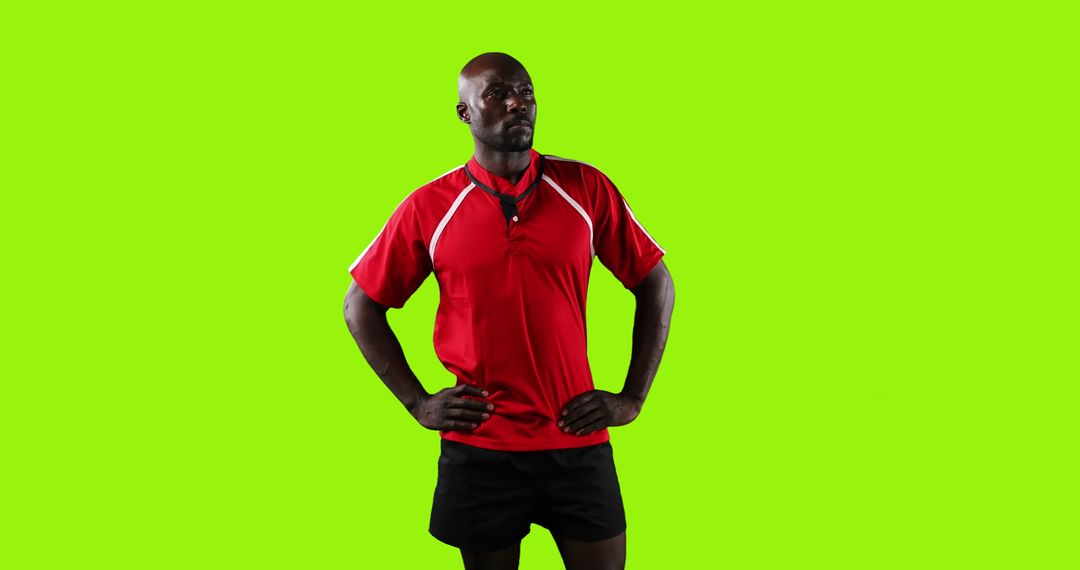 Confident African American Soccer Referee Posing against Green Background - Free Images, Stock Photos and Pictures on Pikwizard.com