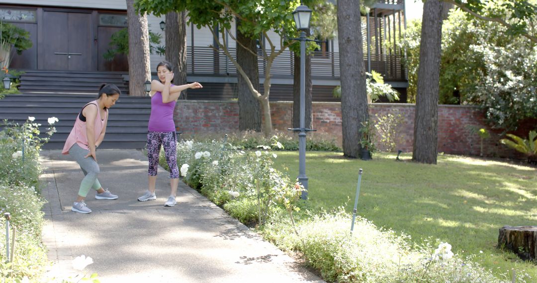 Women Exercising Outdoors in Residential Garden - Free Images, Stock Photos and Pictures on Pikwizard.com