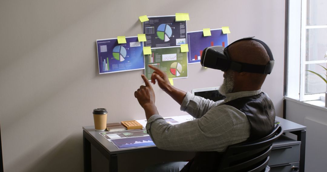 Businessman Analyzing Data with Virtual Reality Headset and Interactive Charts - Free Images, Stock Photos and Pictures on Pikwizard.com