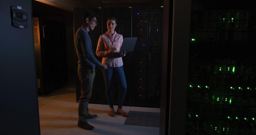 Two IT professionals working with servers in data center - Free Images, Stock Photos and Pictures on Pikwizard.com