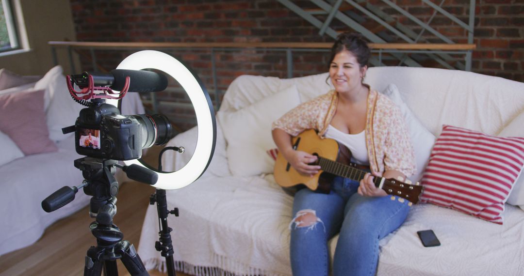 Young Woman Recording Music Video at Home with Guitar and Ring Light - Free Images, Stock Photos and Pictures on Pikwizard.com