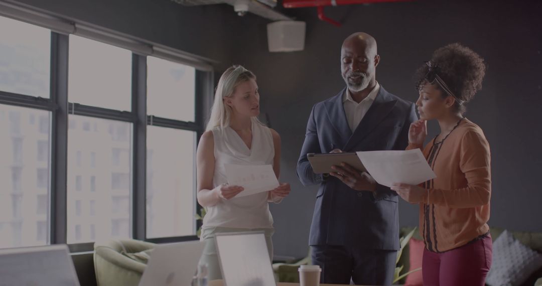 Collaborating Employees Analyzing Corporate Financial Data in Modern Office