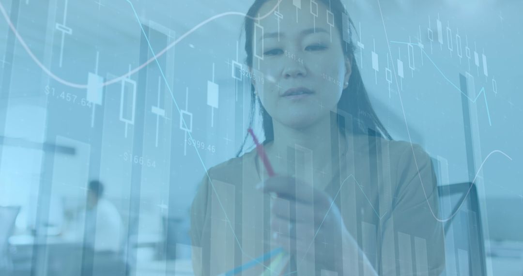 Asian Businesswoman Analyzing Data in Modern Office Environment