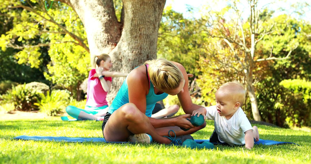 Mother Exercising with Baby in Sunny Park - Free Images, Stock Photos and Pictures on Pikwizard.com