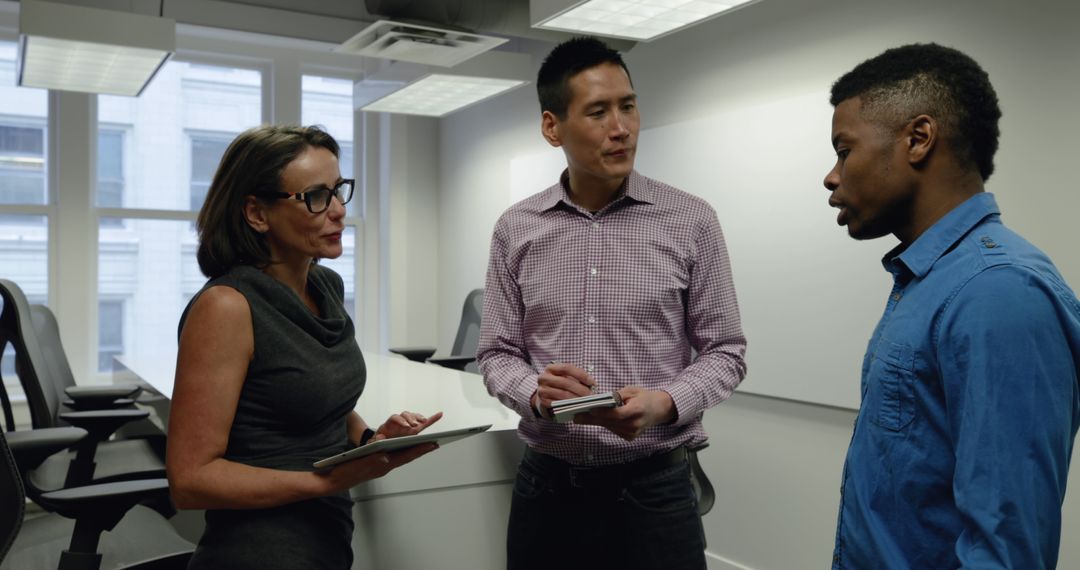 Diverse Professionals Discussing in Modern Office Environment